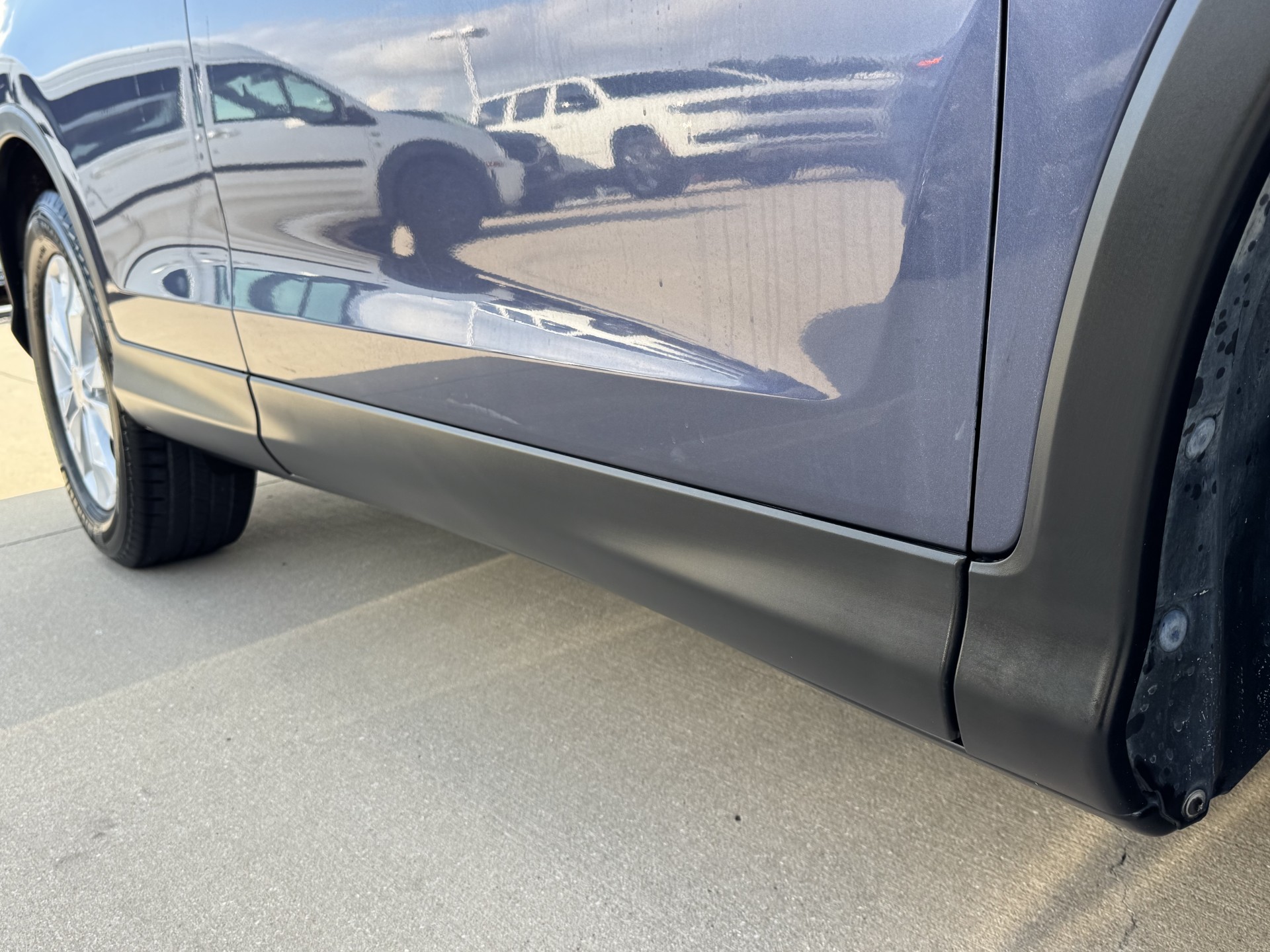 After photo of rocker panel restored to natural black satin finish