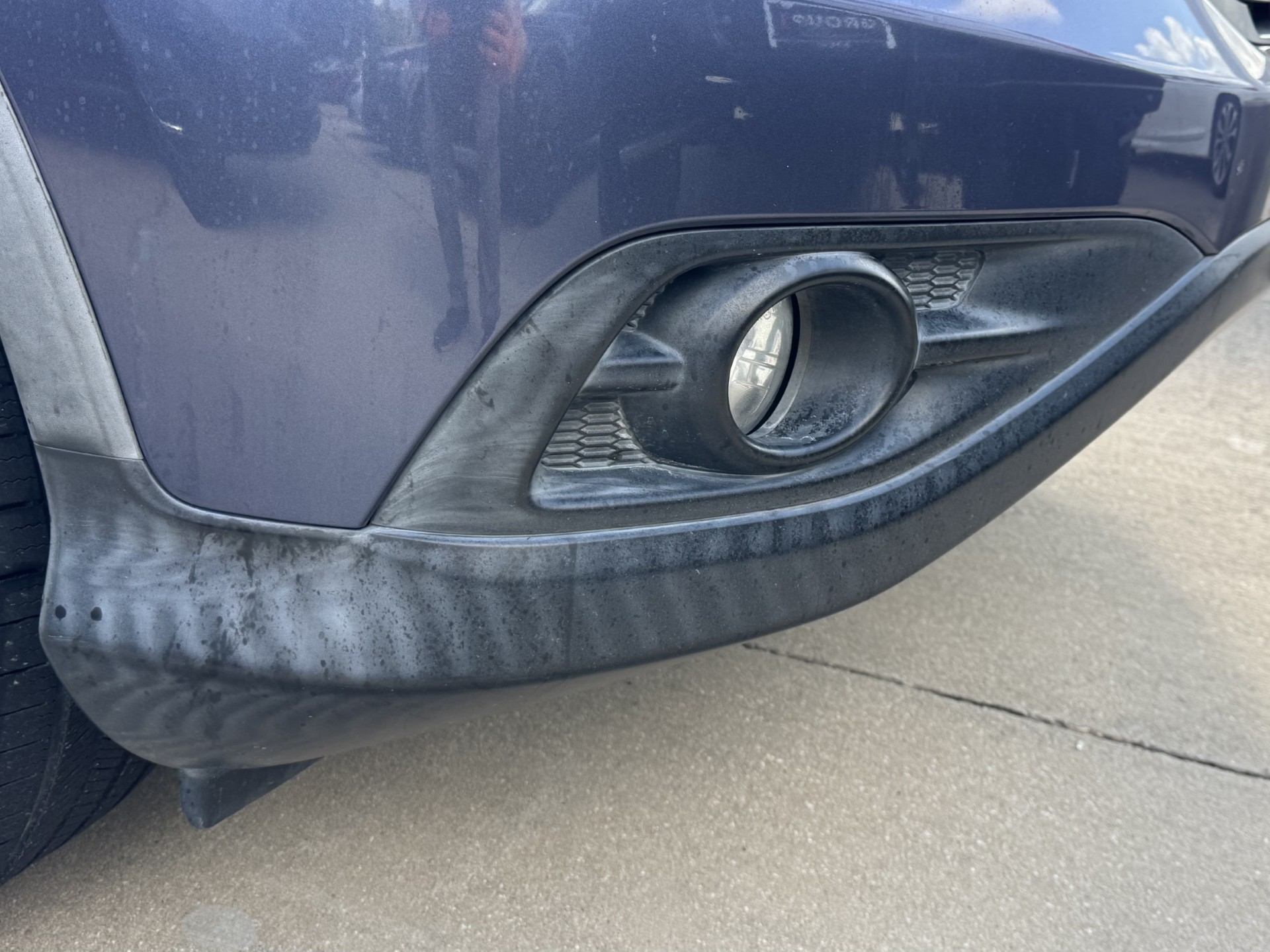 Before photo of dirty faded front fog light surround