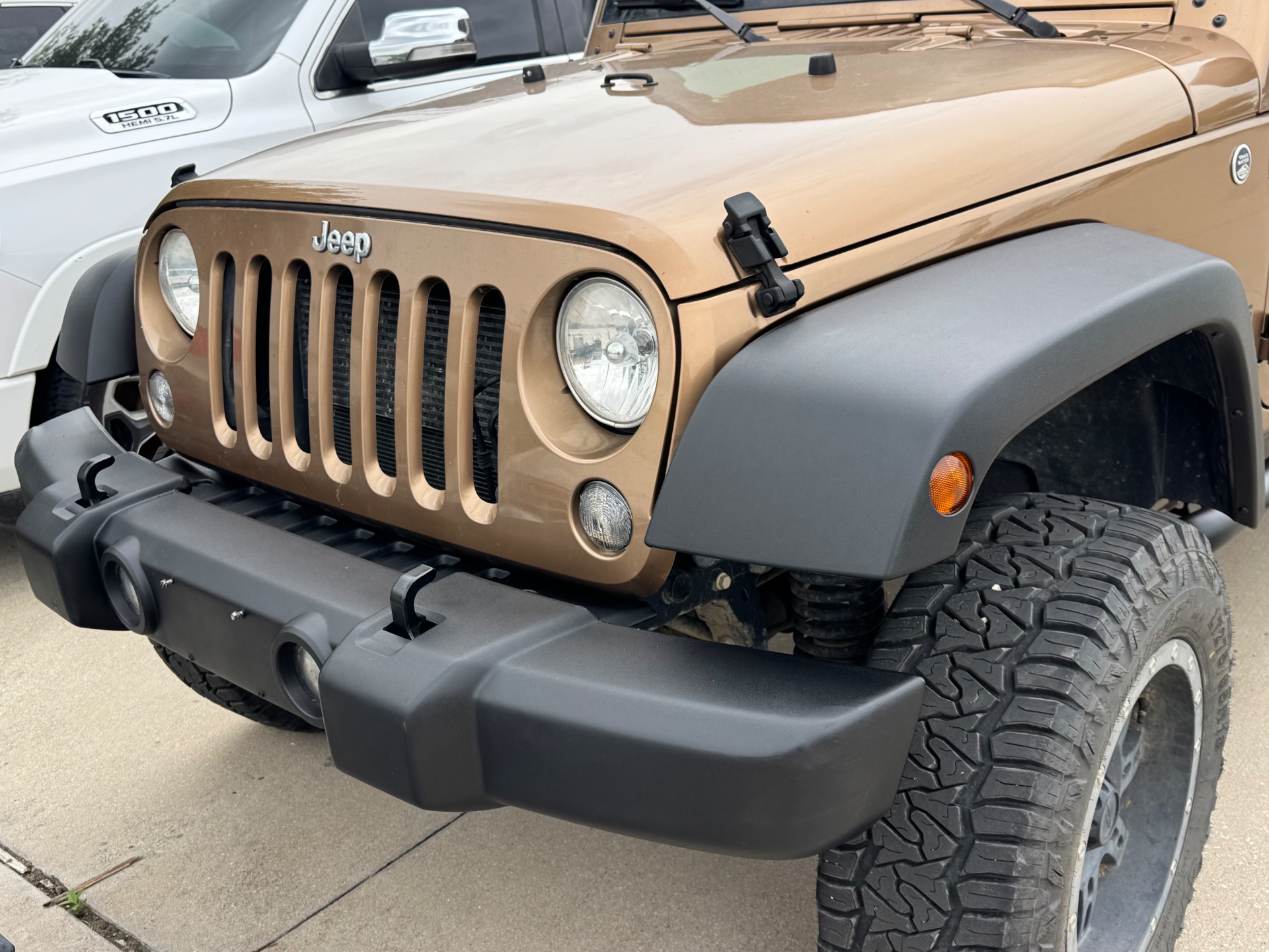 After photo of Jeep Wrangler front bumper and fender flare restored to a natural satin finish