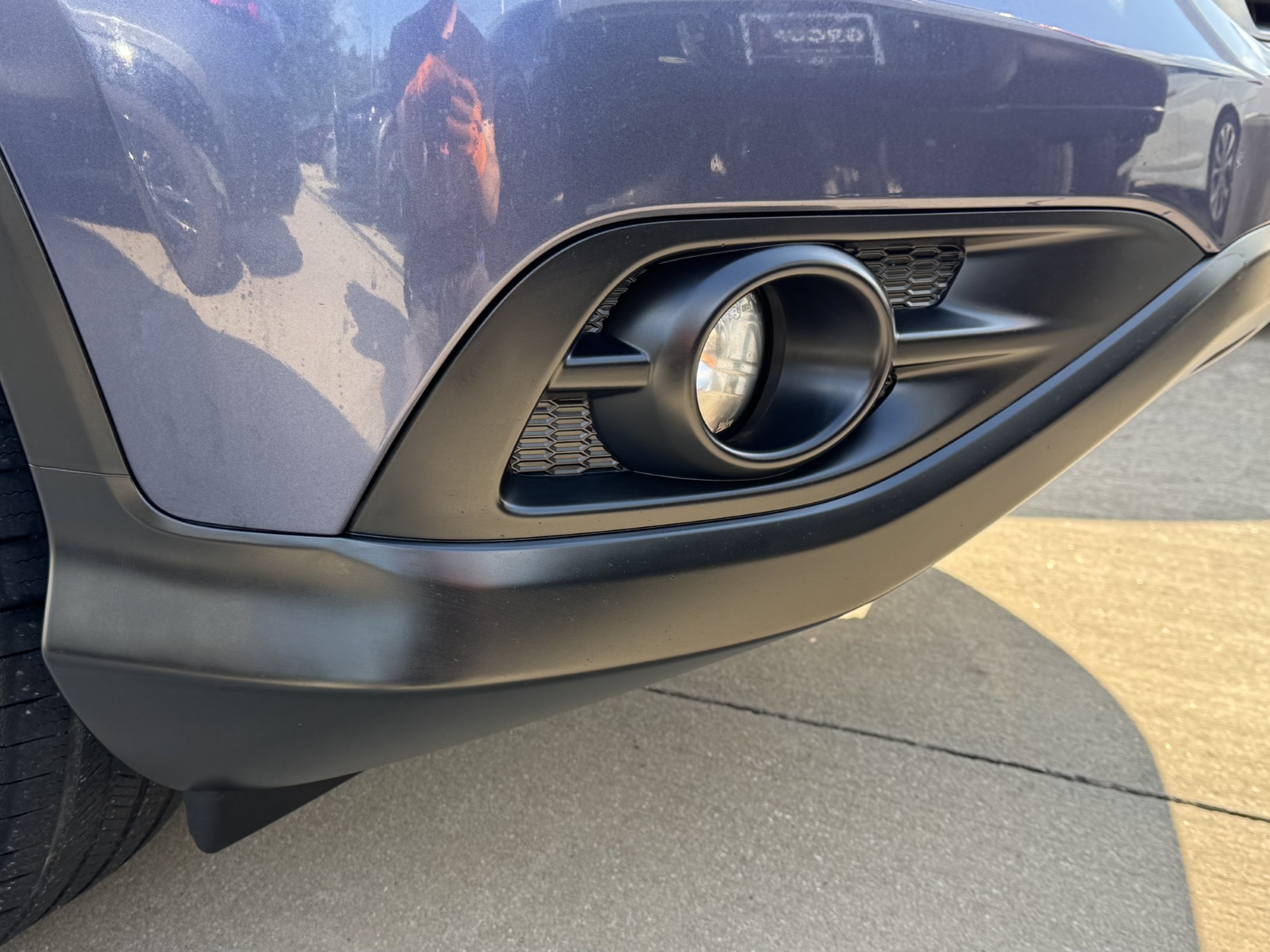After photo of front fog light surround restored to deep factory black