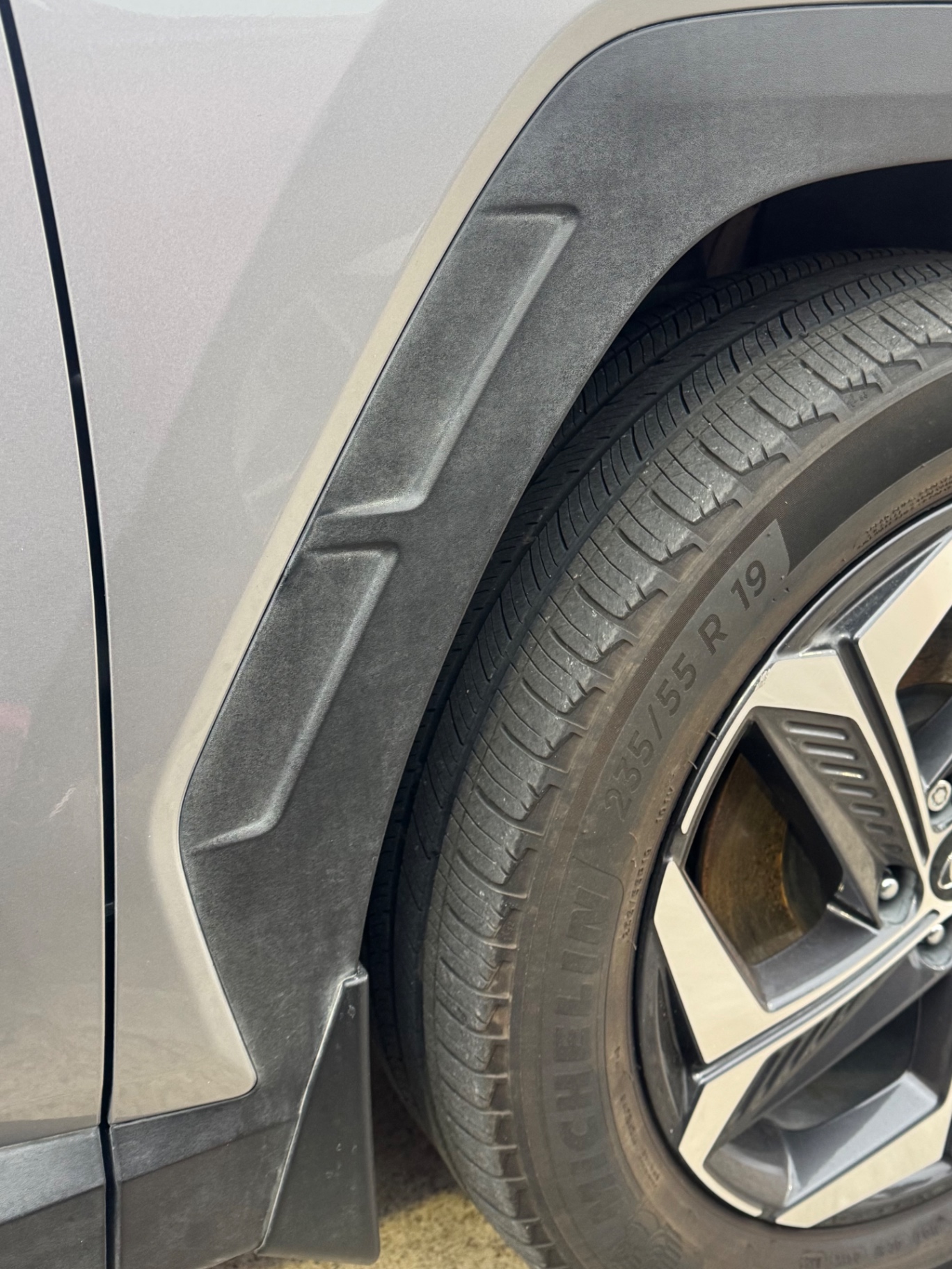 Before photo of chalky oxidized SUV fender flare cladding