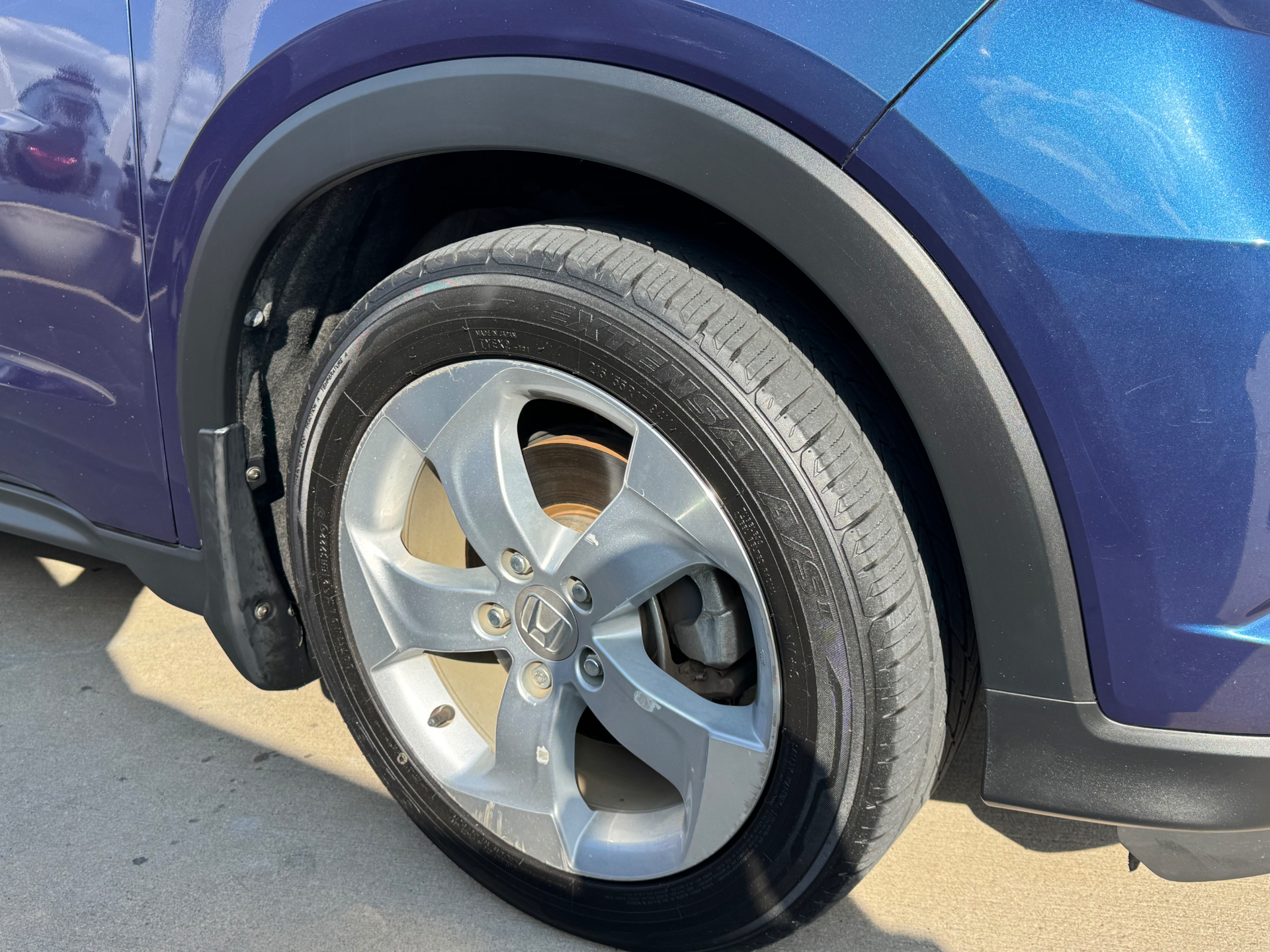 After photo of Honda fender trim restored to a natural black finish