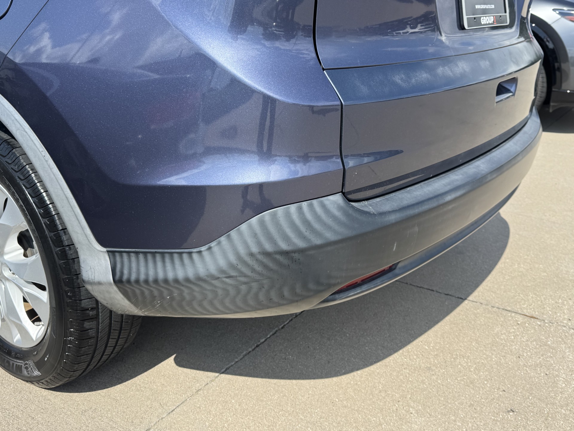 Before photo of sun-faded rear lower bumper trim